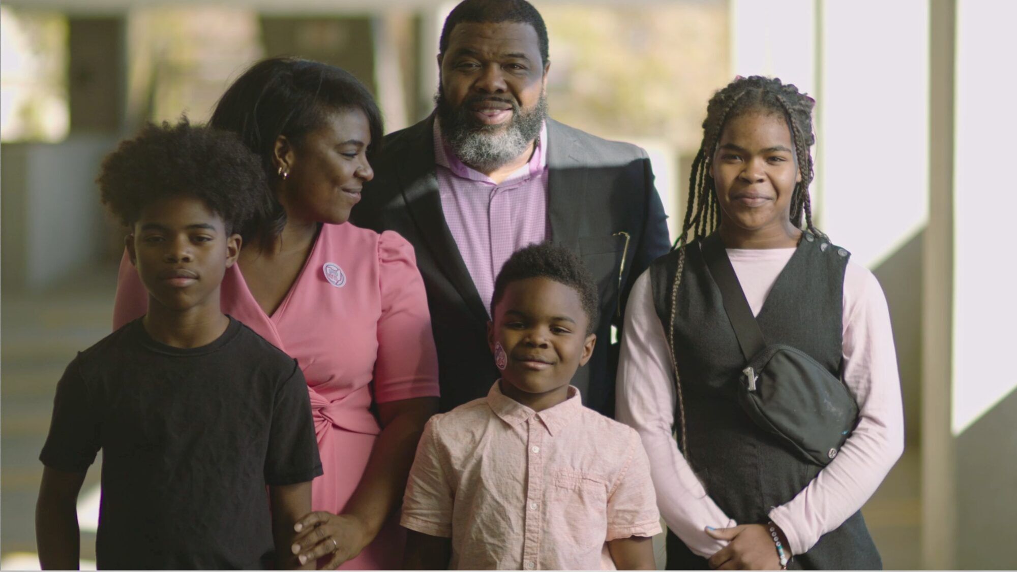 A family stands together in afternoon light