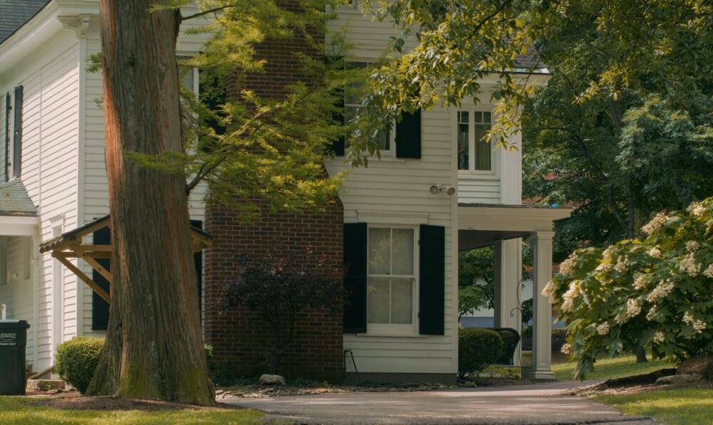 White house framed by trees