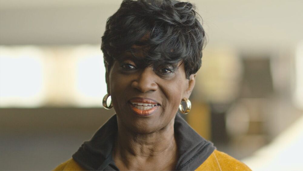 Woman smiling in a soft-focus interview